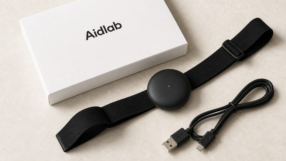 Aidlab box with sensor, strap, and Micro-USB cable